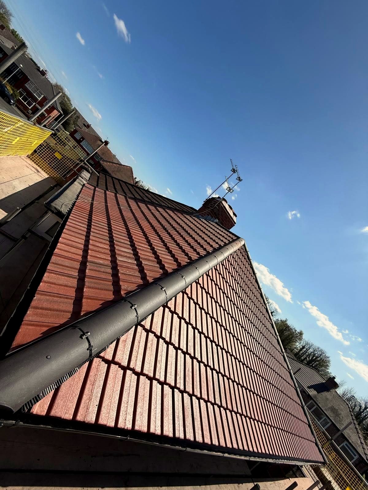 A finished D & P red tile roof in sunshine